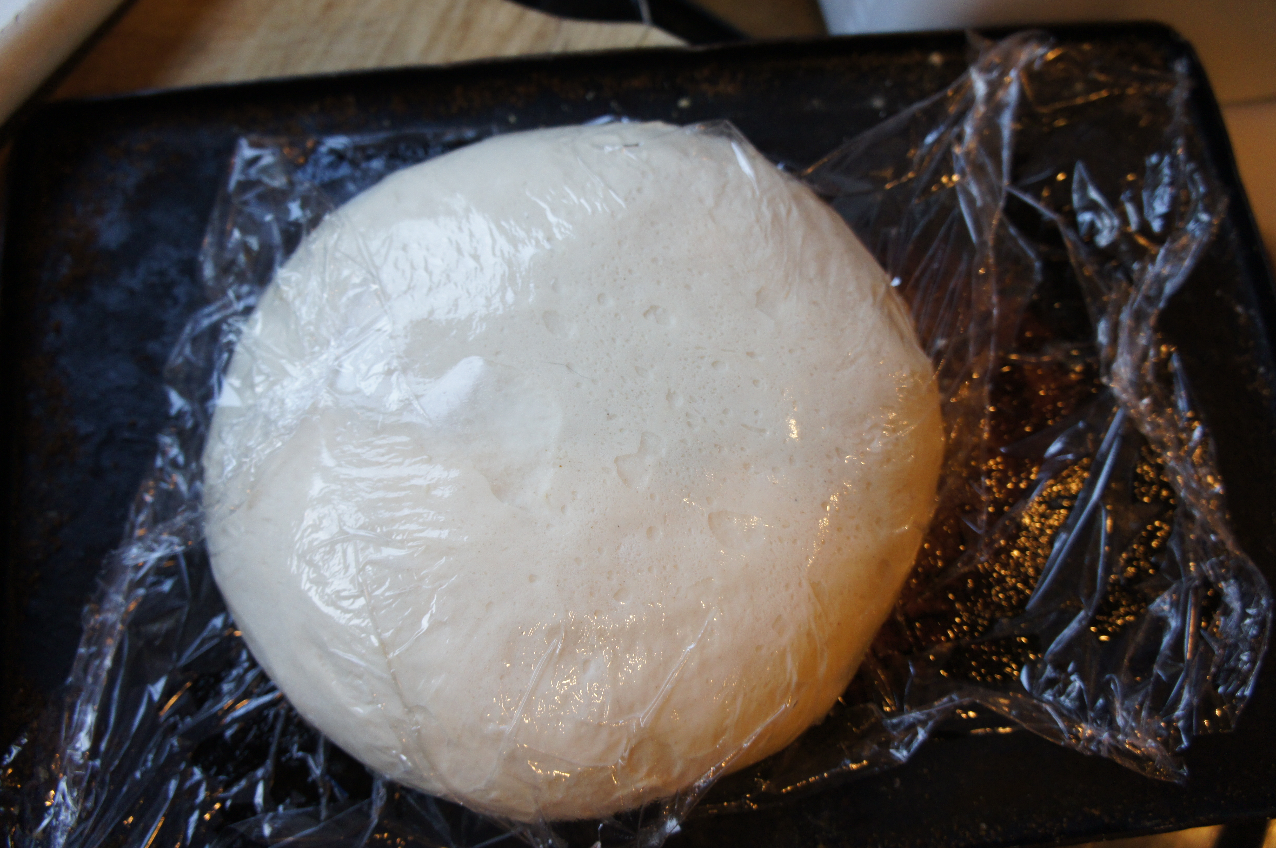 risen dough with clingfilm